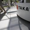 In this May 4, 2016, file photo, visitors walk by a Takata Corp. desk at an automaker's showroom in Tokyo.