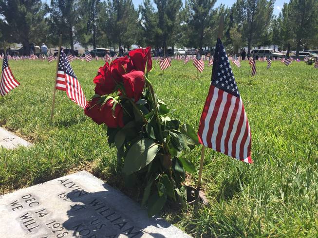 Roses decorate a grave marker at the Southern Nevada Veterans Memorial Cemetery on May 30, 2016. Flowers and American flags were placed at the grave markers in the cemetery over Memorial Day weekend by family members and the Veterans of Foreign Wars.