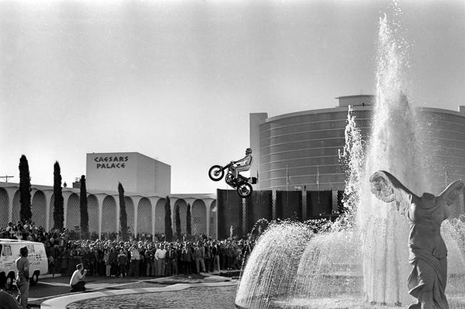 Evel Knievel attempts to jump the fountains at Caesars Palace on Dec. 31, 1967, in Las Vegas. Knievel’s attempt came up short, and he crashed upon landing, suffering a crushed pelvis and femur, fractures to his hip, wrist and both ankles and a concussion that kept him in a hospital.