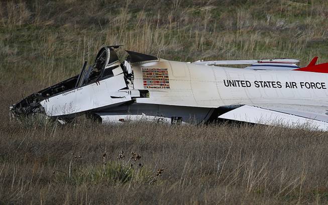 A U.S. Air Force Thunderbird rests in a field where it crashed following a flyover performance at a commencement for Air Force Academy cadets, south of Colorado Springs, Colo., Thursday, June 2, 2016. The pilot ejected safely from the jet. 