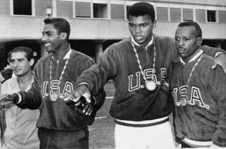 A trio of U.S. boxers wear gold medals at the Olympic village in Rome, September 6, 1960.  From the left are:  Wilbert McClure of Toledo, Ohio, light middleweight; Cassius Clay of Louisville, KY, light heavyweight; and Edward Crook of Fort Campbell, KY, middleweight.  (AP Photo)