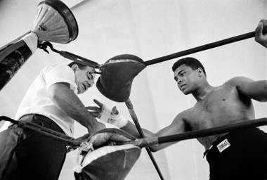 World heavyweight champion Muhammad Ali gets his hand taped by his manager Angelo Dundee before a sparring session Oct. 13, 1966, in Miami. Ali meets Doug Jones in Louisville on Oct. 27 in a charity bout, then puts his title on the line in Houston on Nov. 14 against Cleveland Williams.