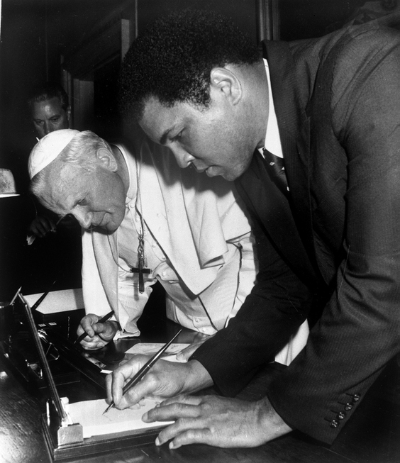 Pope John Paul II looks on as Muhammad Ali, former ...