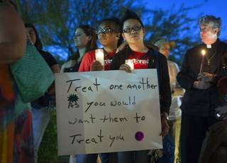 Jennifer White and Lady Binayan hold candles during a vigil and call to action at the Gay & Lesbian Community Center of Southern Nevada on Sunday, June 12, 2016, in Las Vegas. The event was a show of solidarity and support after Sunday morning’s mass shooting at Pulse nightclub in Orlando, Fla., where at least 50 patrons were killed and 53 injured.