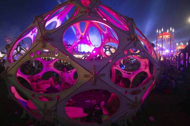 Festivalgoers rest inside one of the sculptures at the Cosmic Meadow during the third night of the Electric Daisy Carnival at the Las Vegas Motor Speedway early Monday morning, June 20, 2016.