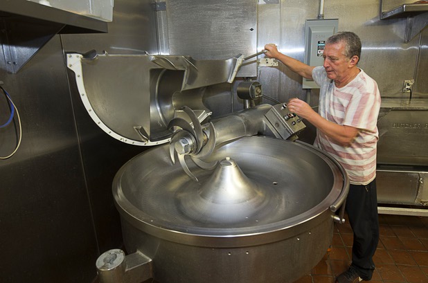 Co-owner Michael Ray shows off an industrial meat chopper at Tina's Gourmet Sausage House, 2101 S Decatur Blvd., Thursday, June 16, 2016.
