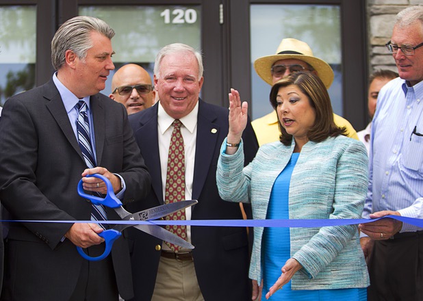 Henderson City Councilwoman Geri Schroeder gives ribbon-cutting advice to Patrick Parker, president of Raintree Investments, during the official opening of the Seasons Market at Lake Las Vegas in Henderson Tuesday, June 21, 2016. Also pictured are Jerry Mansfield, center, a Henderson planning commissioner, and, at far right, Henderson Mayor Andy Hafen. The neighborhood grocery store and specialty market is located in MonteLago Village.