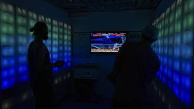 Attendees play a video game during the Small Space Fest at Emergency Arts downtown Las Vegas, Monday, June 20, 2016.
