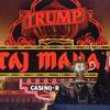 In this April 5, 1990, file photo, Donald Trump stands next to a genie's lamp as the lights of his Trump Taj Mahal Casino Resort light up during ceremonies to mark its opening in Atlantic City, N.J.