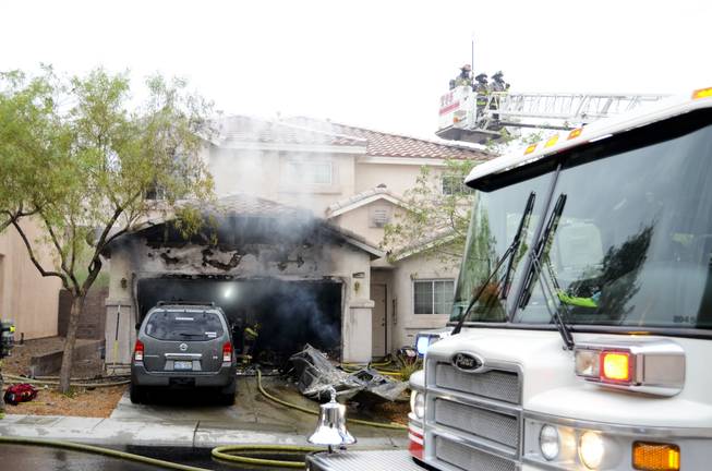 A garage fire was stopped by firefighters before spreading further into a two-story Henderson home located on the 1100 block of Cottonwood Ranch Court, near the intersection of Sandy Ridge Avenue and Summit Grove Drive, Friday morning, July 1, 2016.
