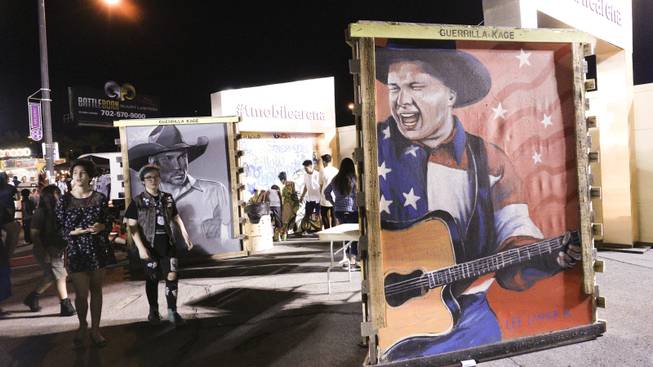 Large scale paintings of country singer Garth Brooks are on display during First Friday festivities at the Arts District in downtown Las Vegas, July 1, 2016.