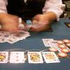 The hands of a card dealer are blurred as she deals a table game at the Bicycle Club card room in Bell Gardens, Calif., May 14, 2003. 