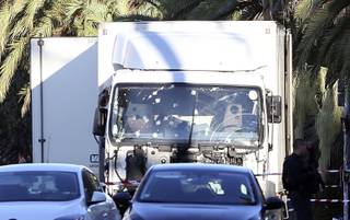 The truck which slammed into revelers late Thursday, July 14, is seen near the site of an attack in the French resort city of Nice, southern France, Friday, July 15, 2016. France has been stunned again as the large white truck mowed through a crowd of revelers gathered for a Bastille Day fireworks display in the Riviera city of Nice. 