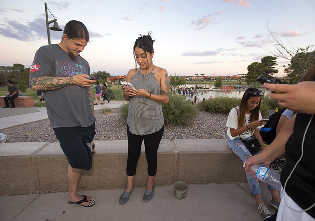 Brent Iozia and Betty Perez play Pokemon Go during a Pokemon Go event at Craig Ranch Regional Park in North Las Vegas Sunday, July 17, 2016. About 1,500 people attended the event according to the Pokemon Go Las Vegas Facebook page.
