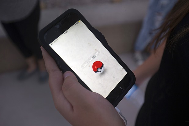 A Pokemon player catches a Rattata during a Pokemon Go event at Craig Ranch Regional Park in North Las Vegas Sunday, July 17, 2016. About 1,500 people attended the event according to the Pokemon Go Las Vegas Facebook page.