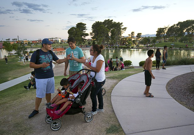 Edward Bravo, left, and his wife Christina play Pokemon Go during a Pokemon Go event at Craig Ranch Regional Park in North Las Vegas Sunday, July 17, 2016. His brother Biaggio Bravo plays at center. About 1,500 people attended the event according to the Pokemon Go Las Vegas Facebook page.