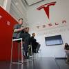 Elon Musk, CEO of Tesla Motors Inc., left, discusses the company's new Gigafactory Tuesday, July 26, 2016, in Sparks, Nev. It's Tesla Motors biggest bet yet: a massive, $5 billion factory in the Nevada desert that could almost double the world's production of lithium-ion batteries by 2018. In the center is J.B. Straubel, Tesla's chief technical officer and at right is Yoshihiko Yamada, executive vice president of Panasonic. (AP Photo/Rich Pedroncelli)