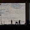 Construction workers are seen in the through uncompleted D section of new Tesla Motors Inc., Gigafactory, Tuesday, July 26, 2016, in Sparks, Nev. It's Tesla Motors biggest bet yet: a massive, $5 billion factory in the Nevada desert that could almost double the world's production of lithium-ion batteries by 2018. (AP Photo/Rich Pedroncelli)