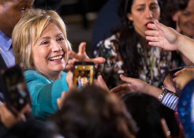 Democratic nominee for President Hillary Clinton reaches for a phone to take a "selfie" with supporters after a campaign rally to talk about her plans for growing the economy and other concerns at IBEW Local 357 on Thursday, August 4, 2016.