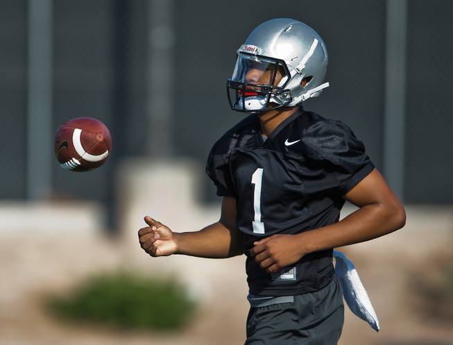 UNLV's QB Armani Rogers tosses the ball as football practice begins during their fall camp on Friday, Aug. 5, 2016.