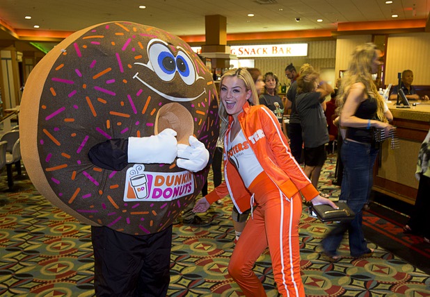 Hooters Girl Kristin Morris poses with an oversized donut during a charity bowling event to support the Nevada Society for the Prevention of Cruelty to Animals (NSPCA) at the Sam's Town Bowling Center Sunday, August 7, 2016. Hooters funneling all of its advertisement money for August into helping a variety of charitable causes.