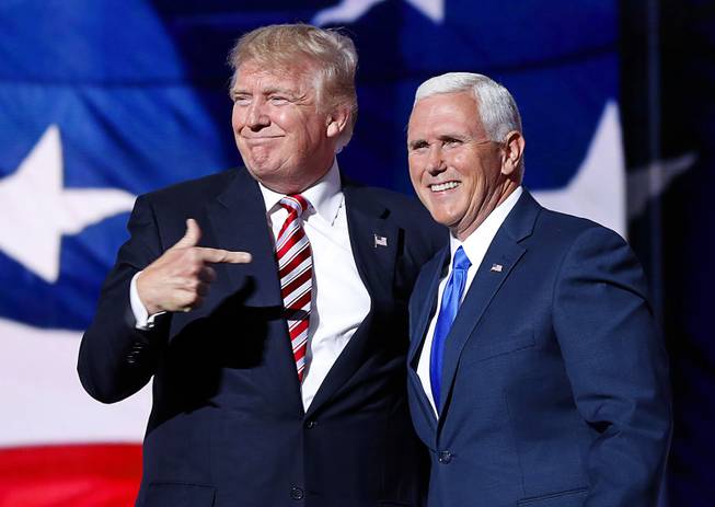 Republican presidential nominee Donald Trump points toward vice-presidential candidate Indiana Gov. Mike Pence after Pence's acceptance speech during the third day session of the Republican National Convention in Cleveland.