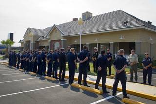 Firefighters, Metro Police officers, and officials from a variety of local agencies form a line of honor to pay their respects to a fallen firefighter at the Davis Funeral Home on South Rainbow Boulevard Wednesday, Aug. 17, 2016. Firefighter Justin Beebe of Vermont died Aug. 13 while fighting the Strawberry Fire in Great Basin National Park.