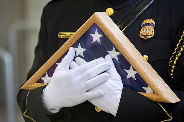 A member of the Homeland Security Investigations Honor Guard holds a flag during an opening ceremony for the Federal Justice Tower, a new office building in downtown Las Vegas, Thursday, Aug. 18, 2016. The flag, which has been flown over the capital in Washington D.C., was presented to the family of developer Stephen Biagiotti. Stephen Biagiotti, founder of SDA Inc., died in 2015 before the completion of the building.