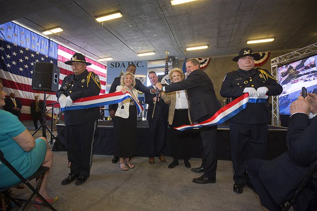 Officials cut a ribbon during an opening ceremony for the Federal Justice Tower, a new office building in downtown Las Vegas, Thursday, Aug. 18, 2016. The building will provide office space for multiple components of U.S. Immigration and Customs Enforcement, the U.S. Attorneys Office for the District of Nevada, the Federal Protective Service and the Department of Labors Office of the Inspector General.