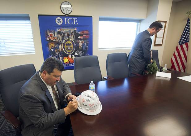 Joseph Macias, special agent in charge for Homeland Security Investigations, signs a hard hat in the Federal Justice Tower, a new office building in downtown Las Vegas, Thursday, Aug. 18, 2016. The building will provide office space for multiple components of U.S. Immigration and Customs Enforcement, the U.S. Attorneys Office for the District of Nevada, the Federal Protective Service and the Department of Labors Office of the Inspector General.