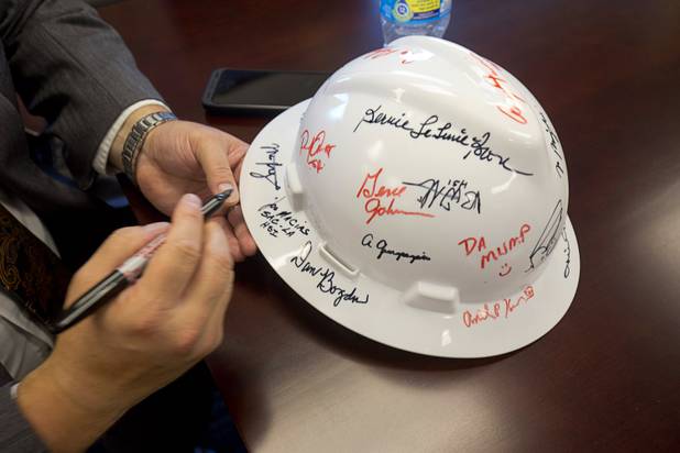 Joseph Macias, special agent in charge for Homeland Security Investigations, signs a hard hat in the Federal Justice Tower, a new office building in downtown Las Vegas, Thursday, Aug. 18, 2016. The building will provide office space for multiple components of U.S. Immigration and Customs Enforcement, the U.S. Attorneys Office for the District of Nevada, the Federal Protective Service and the Department of Labors Office of the Inspector General.