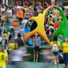 A woman poses for a photo Saturday, Aug. 19, 2016, at a sculpture of the Rio Olympics logo at a crowded Olympic Park at the 2016 Summer Olympics in Rio de Janeiro. The sculpture shows people jubilantly joining hands to represent the culture of Rio.