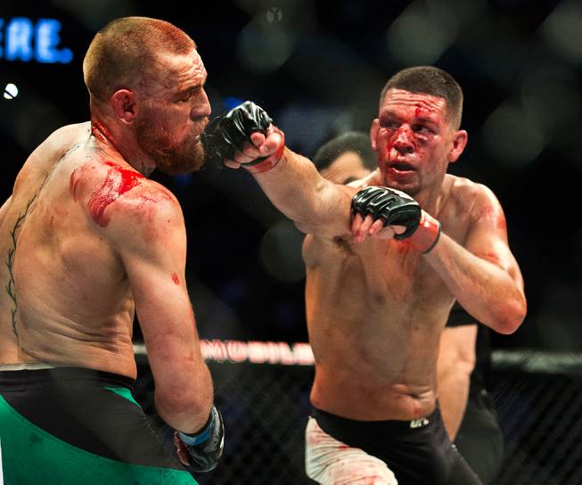 Welterweight Conor McGregor appears defenseless from another blow by Nate Diaz during their UFC 202 fight night action at the T-Mobile Arena on Saturday, August 20, 2016.