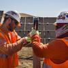Workers install a rotator hinge at First Solar’s energy plant near Cholame, Calif., Aug. 18, 2016. Apple recently received a federal designation for its energy subsidiary that allowing it to become a wholesale seller of electricity, and will purchase the electricity generated by the plant to power its stores in California. 