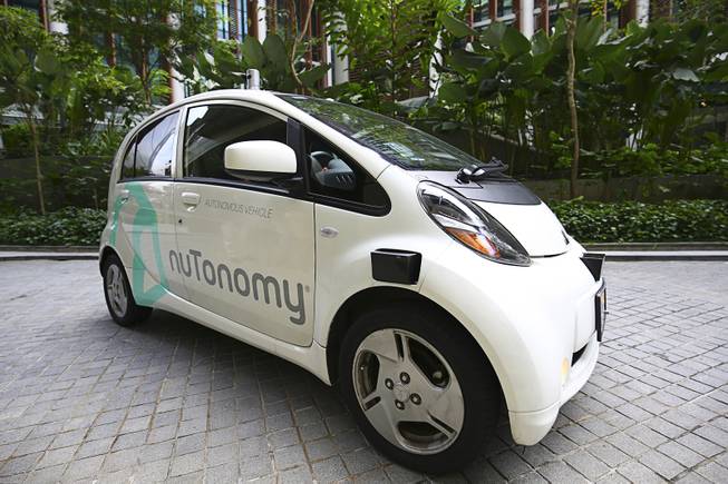 An autonomous vehicle is parked for its test drive in Singapore Wednesday, Aug. 24, 2016. The world’s first self-driving taxis, operated by nuTonomy, an autonomous vehicle software startup, will be picking up passengers in Singapore starting Thursday, Aug. 25. The service will start small — six cars now, growing to a dozen by the end of the year. 