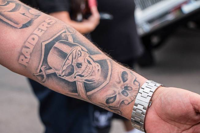 A man shows off his Oakland Raiders tattoo Saturday at the Las Vegas Raiders Nation Cantina.