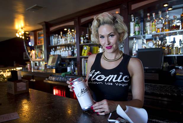 Bartender Carrie Wilds holds an Atomic-themed beer  "crowler" at Atomic Liquors, 917 Fremont St., in downtown Las Vegas Sunday, Aug. 28, 2016.