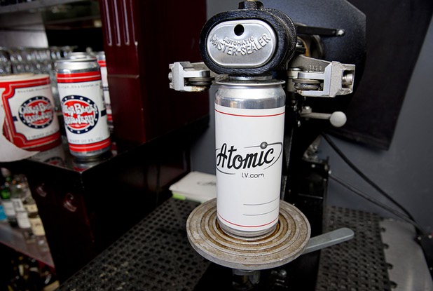 An Atomic-themed beer "crowler" is shown on a canning machine at Atomic Liquors, 917 Fremont St., in downtown Las Vegas Sunday, Aug. 28, 2016.