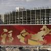 In this Friday, Aug. 26, 2016, photo, a wall with symbols of China partially blocks the view of the Resorts World property in Las Vegas. The Asian-themed casino property is projected to open in 2019. 