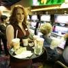 Beverage server Christa Evanko delivers drinks at the opening of the new Mohegan Sun at Pocono Downs casino in Wilkes-Barre, Pa., in November 2006.