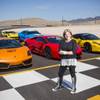 SPEEDVEGAS. Vice President of Business Allison Raskansky poses for a photo with a selection of cars available to race at their 1.5 mile long racetrack, Thursday, June 2, 2016.