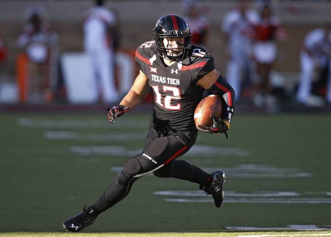 In this Oct. 31, 2015, file photo, Texas Tech wide receiver Ian Sadler carries the ball during an NCAA college football game against Oklahoma State in Lubbock, Texas. No one is saying Sadler (42 catches for 596 yards and three touchdowns) needs to double his production and make up for what Jakeem Grant did alone. But Mahomes will need reliable slot guys who can turn a short gain into a big one occasionally and either Sadler or Cameron Batson will be asked to fill that role.