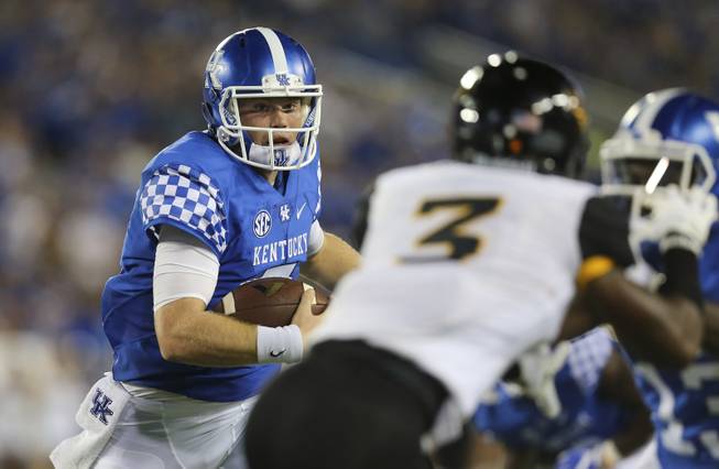 Kentucky quarterback Drew Barker runs with the ball to set up a touchdown late in the first half of an NCAA college football game against Southern Mississippi, Saturday, Sept. 3, 2016, in Lexington, Ky. (AP Photo/David Stephenson)