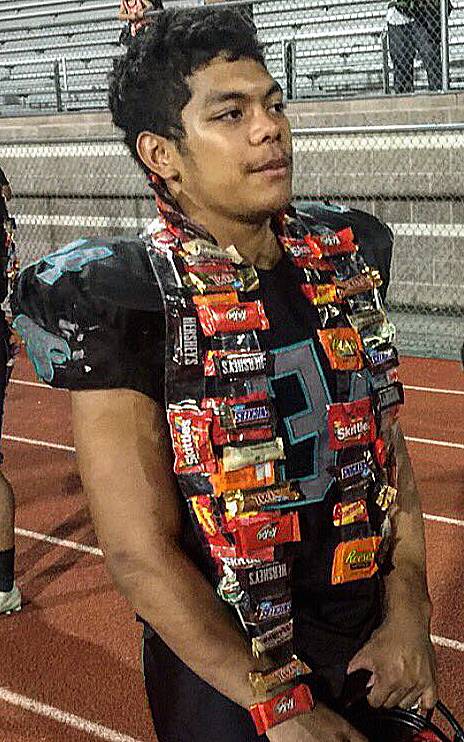 Silverado's Keikiokalani Misipeka dons a well-earned lei, adorned with candy bars, after rushing for 200 yards in a win over Faith Lutheran, Friday, Sept. 16, 2016.