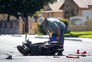 A Metro Police investigator looks over an accident scene after an accident involving a scooter at 21st Street and Searles Avenue on Sunday, Sept. 18, 2016.