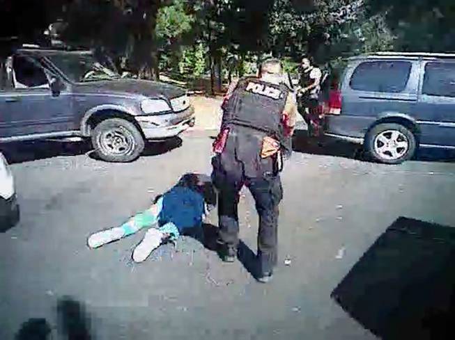This image made from video provided by the Charlotte-Mecklenburg Police Department on Saturday, Sept. 24, 2016, shows Keith Scott on the ground as police approach him Sept. 20, 2016, in Charlotte, N.C.