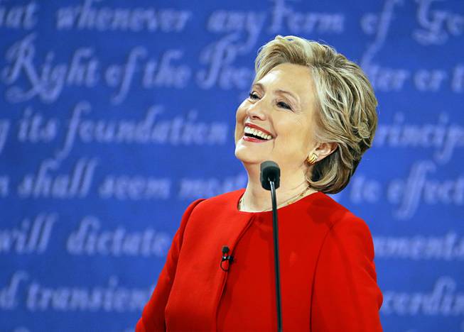 Democratic presidential nominee Hillary Clinton laughs to Republican presidential nominee Donald Trump during the presidential debate at Hofstra University in Hempstead, N.Y., Monday, Sept. 26, 2016. (AP Photo/Julio Cortez)