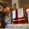 In this Sunday, Sept. 18, 2016, photo, Shelley Ewalt sits in her home, in Princeton, N.J., near an amber-colored CVS pharmacy prescription bottle, right, and two uniquely designed red ones from Target.