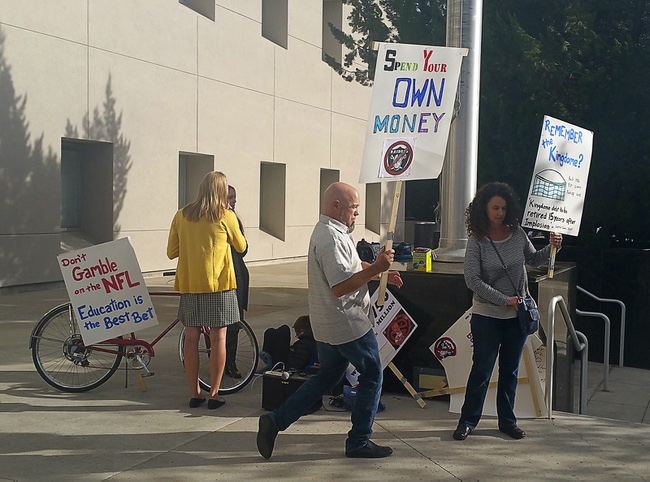 A small group of protesters gather outside the Nevada Capitol building in Carson City, Monday, Oct. 10, 2016. Lawmakers are meeting to vet a public financing plan for a proposed NFL stadium in Las Vegas, but critics say tax money is better used for education. 