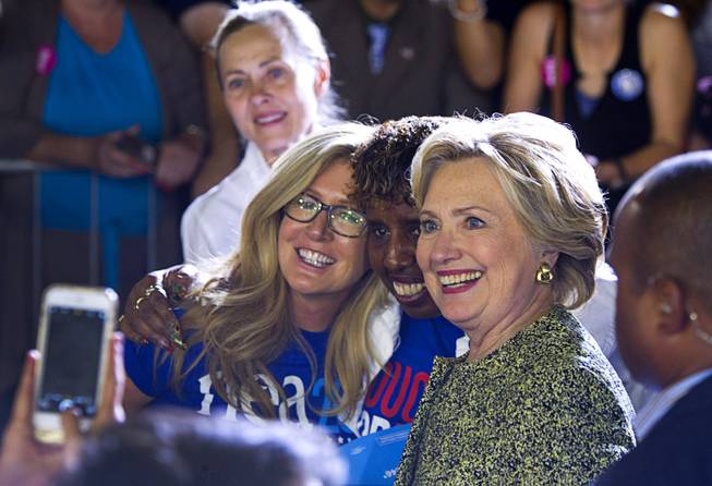 Democratic U.S. presidential nominee Hillary Clinton poses with supporters during a campaign rally at the Smith Center for the Performing Arts in Las Vegas  Wednesday, Oct. 12, 2016.